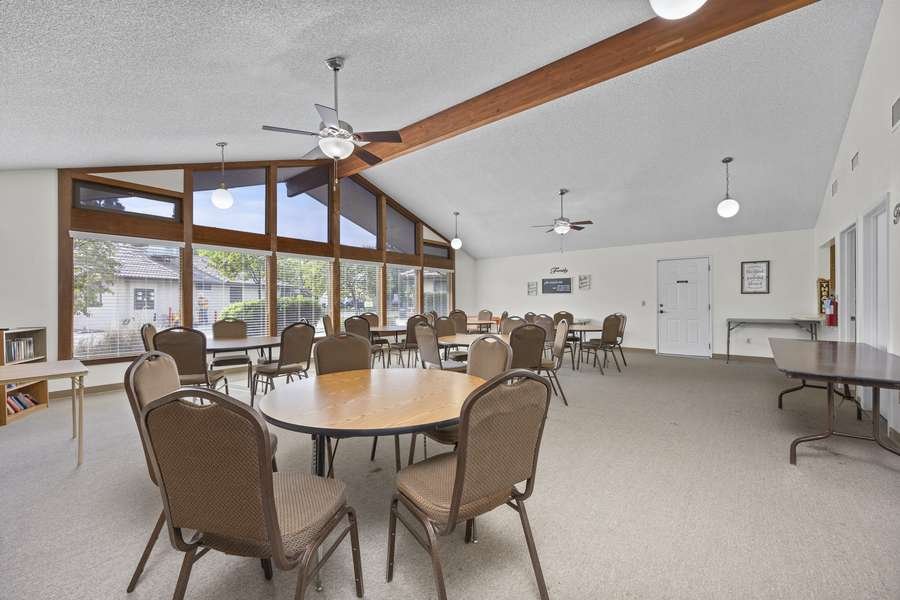 Vaulted activity hall with large windows and seating