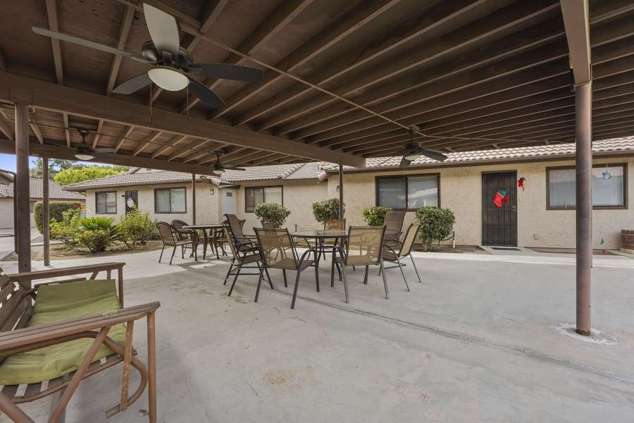 Covered outdoor patio with tables and chairs